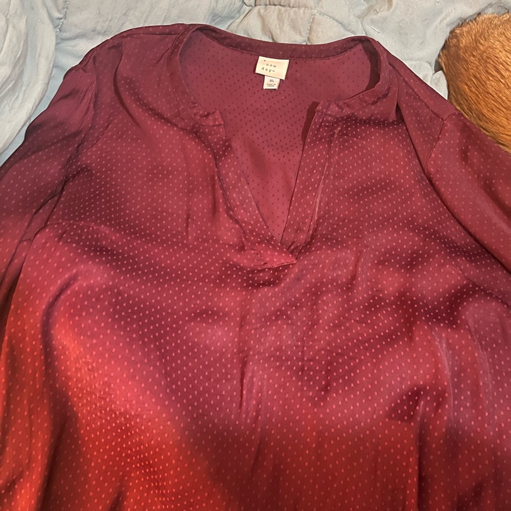 A.new day size XL in maroon. Long sleeve with a button on the end of the sleeve.